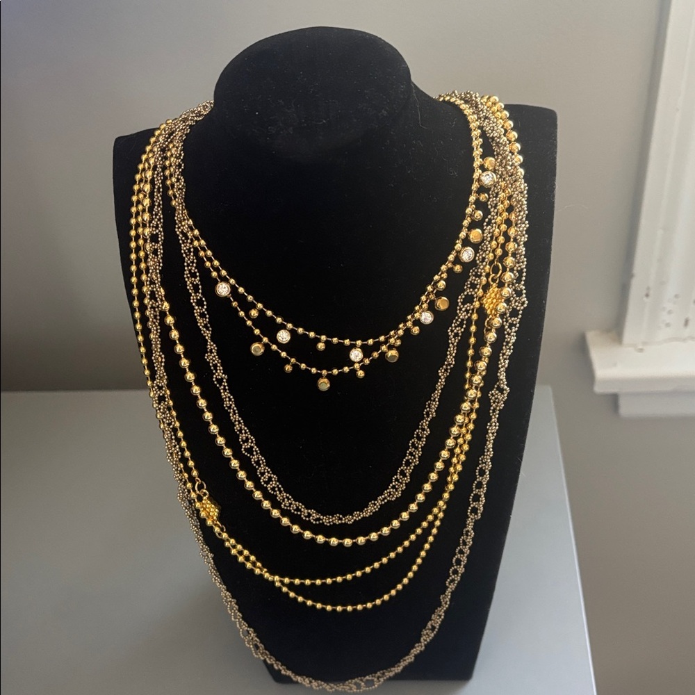6 goldtone layered necklaces.